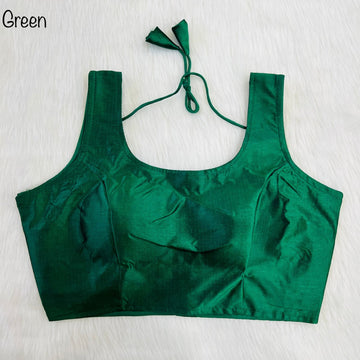 Green crop top with ruffled details on a light background