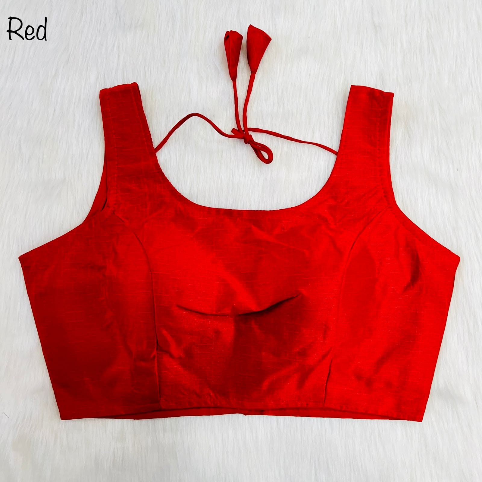 Red crop top with tied straps on a white background