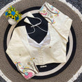 Embroidered white blouse with black vest 