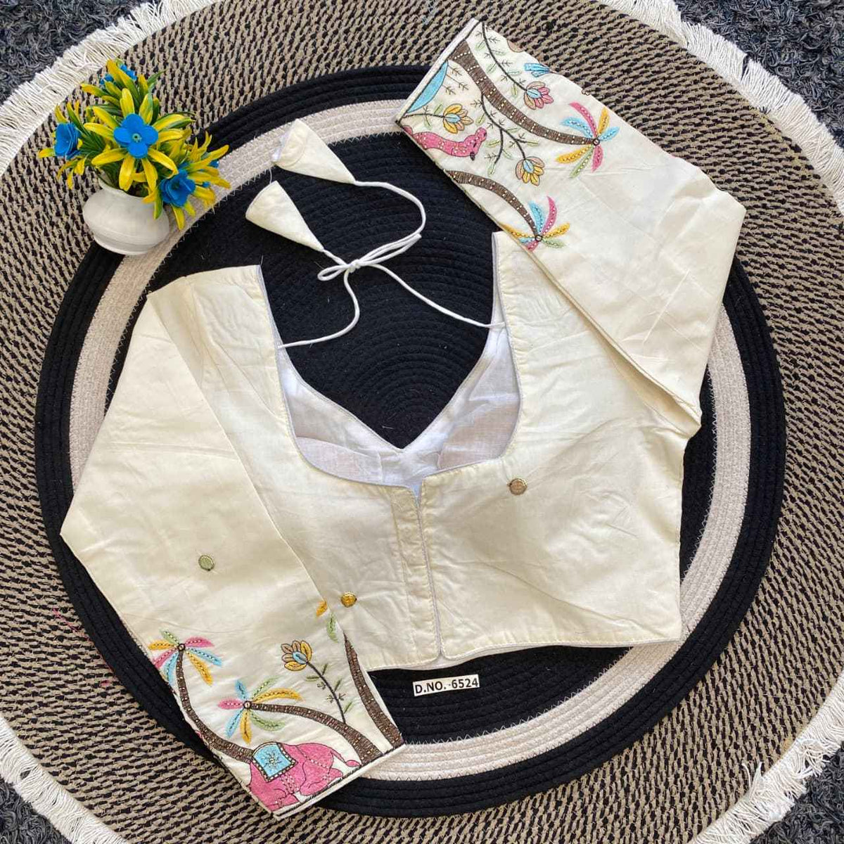 Embroidered white blouse with black vest 